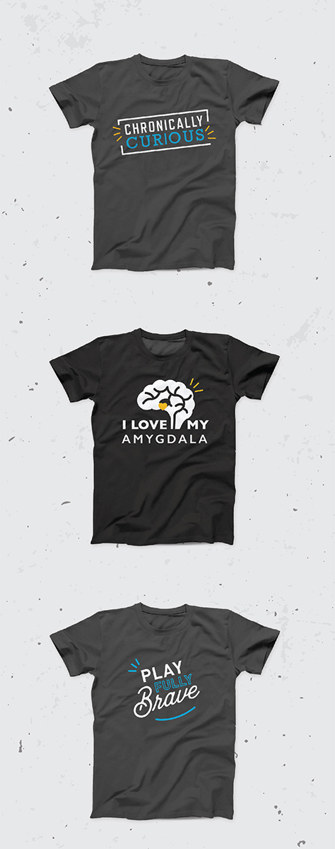 Three branded Sarah Noll Wilson T-shirts reading "Chronically Curious," "I Love My Amygdala" and "Play Fully Brave"
